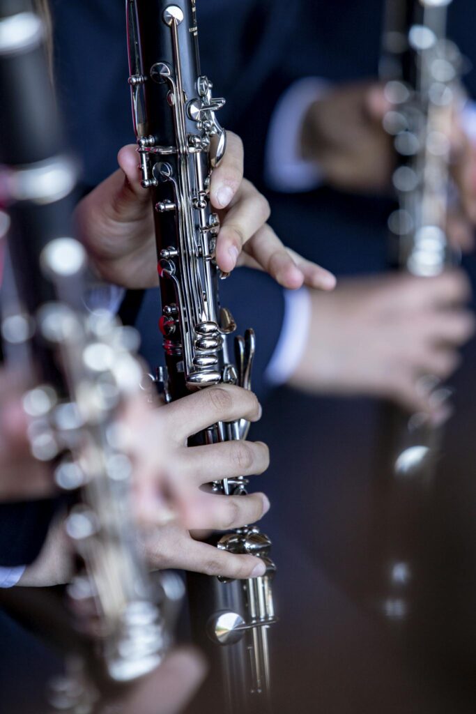 Close-up of musicians playing clarinets during a performance in Barcelos, Portugal.